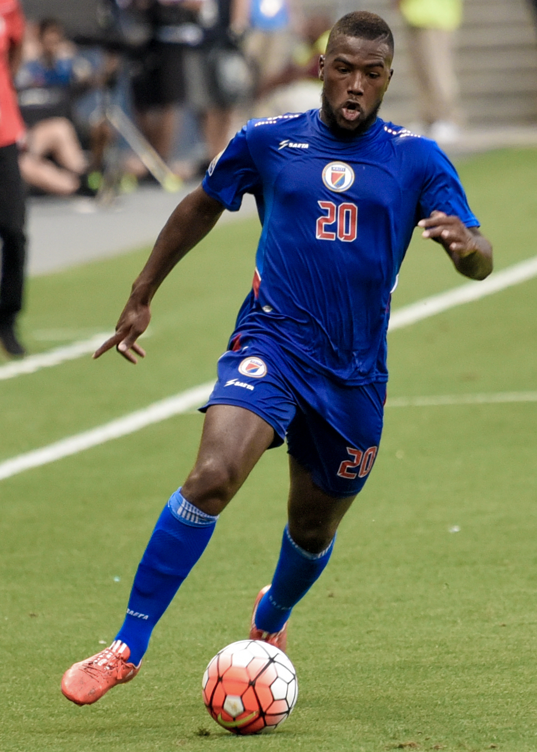 Duckens Nazon playing for Haiti's Men's National Team against Honduras.